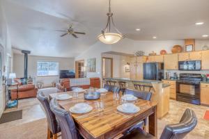 a kitchen and living room with a wooden table and chairs at Indio Cabin in Bend