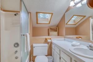 a bathroom with a toilet and a sink at Owls Nest - Meredith Lodging in Sunriver +34 photos