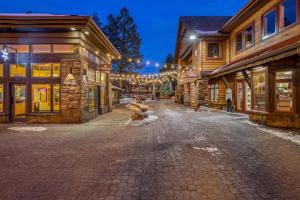 a cobblestone street in front of some buildings at Owls Nest - Meredith Lodging in Sunriver