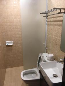 a bathroom with a toilet and a sink at Mali House in Luang Prabang