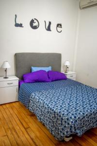 a bedroom with a bed with a blue and purple comforter at Calido alojamiento en San Telmo EH in Buenos Aires