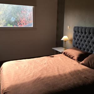 a bedroom with a large bed and a window at Casa Balcón del Golf in Sierra de los Padres