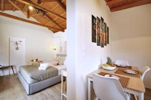 a living room with a table and a bed in a room at Dafnes in Skopelos Town