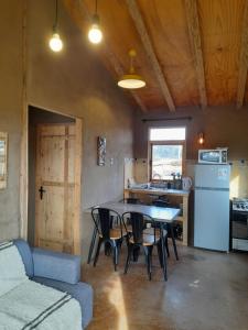 a kitchen with a table and chairs in a room at Eco Parcela La Chacra in Catapilco