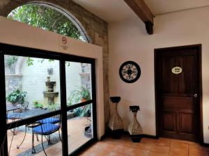 an open door to a patio with a table and chairs at Villa Sueño Azul B&B in Guanajuato