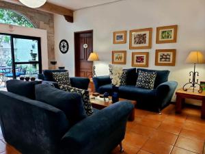 a living room with blue couches and a table at Villa Sueño Azul B&B in Guanajuato