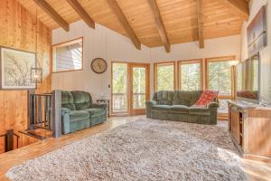a living room with two couches and a tv at Sunriver Treehouse in Sunriver