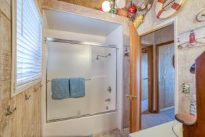 a bathroom with a shower with a blue towel at Nestle Inn - Meredith Lodging in Neskowin +37 photos