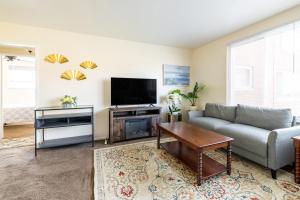 a living room with a couch and a flat screen tv at Georgetown Villas 2-1b Ideal for long stays! in Fairview Park