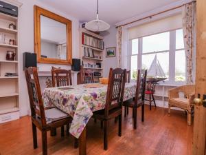 a dining room with a table and chairs and a window at 6 Gloster Terrace in Folkestone