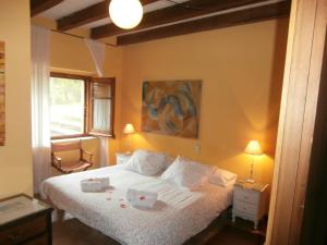 a bedroom with a bed with two dishes on it at Can Sisó in Crespiá