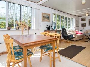 a living room with a wooden table and chairs at Holiday home Odder XXVI in Odder