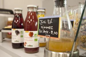 a kitchen counter with bottles of honey and a sign at Logis H&ocirc;tel Duquesne in Nantes