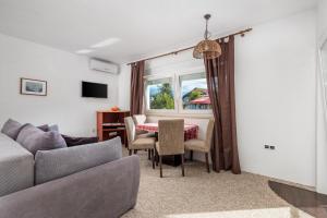 a living room with a couch and a table at Selak Apartments in Grabovac