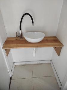 a sink in a bathroom with a wooden counter at Przystanek Amsele in Åmsele