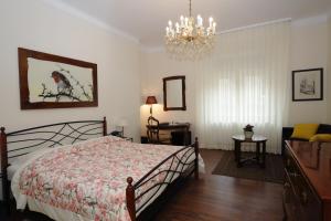 a bedroom with a bed and a chandelier at B&B Fotić in Zagreb
