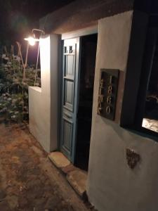 a door to a house with a sign on it at Latmos 1860 in Skala