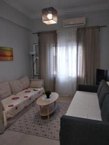 a living room with a couch and a table at CENTRAL TOWN HOUSE 60m2**** in Piraeus