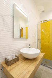 a bathroom with a large white sink and a mirror at Baia Flegrea Meublè in Bacoli