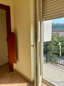 a sliding glass door with a view of a balcony at La Divina in Cosenza