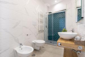 a bathroom with a toilet and a sink at Baia Flegrea Meublè in Bacoli