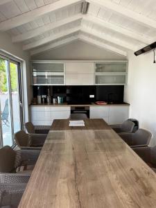 a conference room with a wooden table and chairs at Villa Birk in Barbat na Rabu