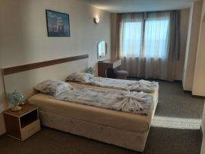 Llit o llits en una habitació de Hotel Orchidea