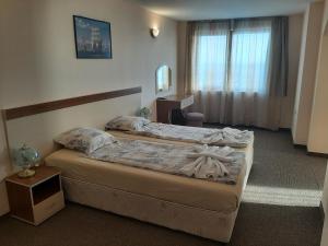 Postel nebo postele na pokoji v ubytování Hotel Orchidea