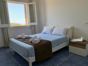 a bedroom with a bed with towels on it at L'oasi di Pace in Pantelleria