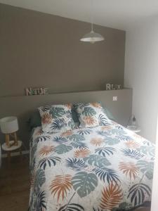 - une chambre avec un lit et une couette colorée dans l'établissement Petite maison charmante en baie de Saint-Brieuc entre Paimpol et Erquy Wifi et parking gratuit, à Ploufragan