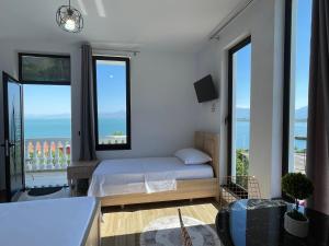 a bedroom with a bed and a view of the ocean at four generation hotel in Shirokë