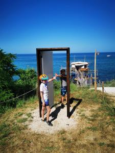 two young boys standing in front of a door at Villa Borsacchio in Roseto degli Abruzzi