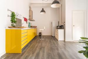 a kitchen with a yellow island in a room at 120 sqm Loft-style Apartment Beach Royal Marina in Valencia +13 photos
