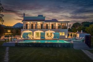 a house with a swimming pool in the yard at Rivazzurra Beachfront Luxury Villa in Lithakia