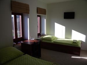 A bed or beds in a room at Penzion Farmer Kapušany