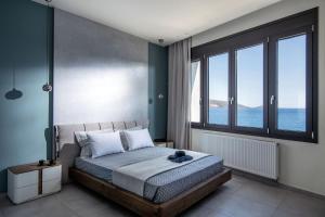 a bedroom with a bed with a large window at La Vista Apartment in Agios Nikolaos