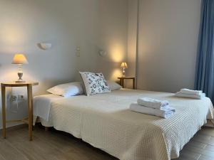 a bedroom with two beds with towels on them at Sofia Studios in Benitses