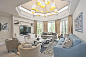 a living room with a blue couch and chairs at Fountain House in London