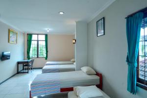 Postel nebo postele na pokoji v ubytování EC Pondokan