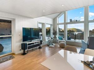 a living room with a large flat screen tv at 8 person holiday home in lyngdal-By Traum in Lyngdal