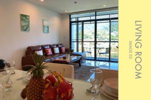 a living room with a table with fruits on it at Tranquil Condo close to Beach in Kamala Beach