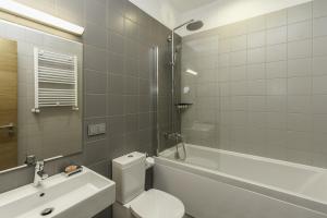 a bathroom with a toilet and a tub and a sink at Le Port Boutique Apart Hotel in Batumi +76 photos