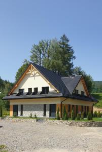 a house with solar panels on the roof at Apartamenty Beskidzka 92 in Korbielów