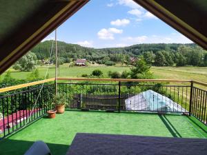 a balcony with a view of a yard at Agroturystyka Jacnia in Jacnia