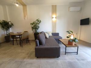 a living room with a couch and a table at Coritos apartments Corfu in Kontokali