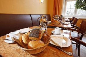 una mesa con una cesta de pan. en Hotel Amsterdam en Hamburgo