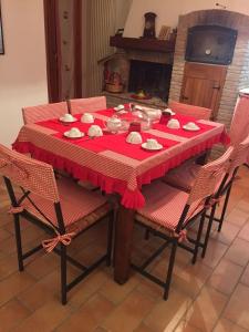 a dining room table with a red table cloth at B&B Margherita Le Fiabe in SantʼAgata Feltria