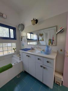a bathroom with a sink and a bath tub at Barud Gedera Israel in Gedera