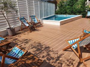 a patio with three chairs and a swimming pool at Sun and Sea Apartments in Budva