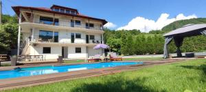 a villa with a swimming pool and a house at Villa Greenfield in Sarajevo